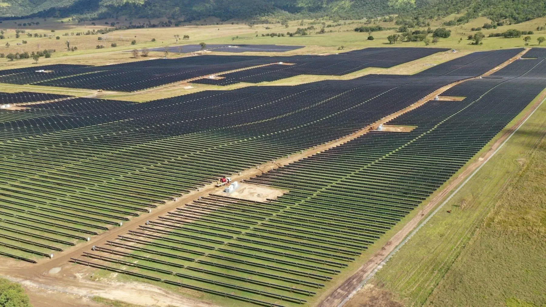 Aerial view of the Woolooga Solar Farm in Queensland, rows of Risen modules to the horizon